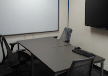 table 3 chairs, a monitor and mounted screen