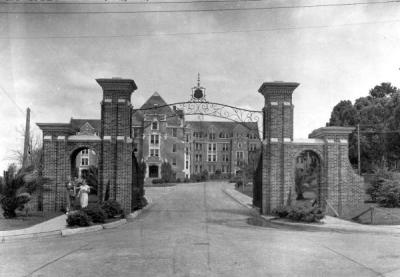 black and white photo of brick columns and building