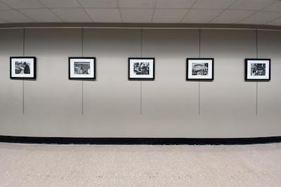 5 framed pictures hanging on the wall of Strozier Library third floor