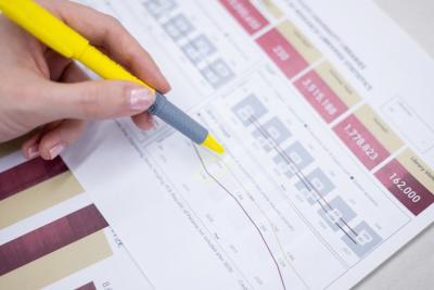 A person highlighting a spreadsheet